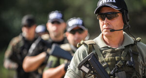 image shows a line of uniformed police officers